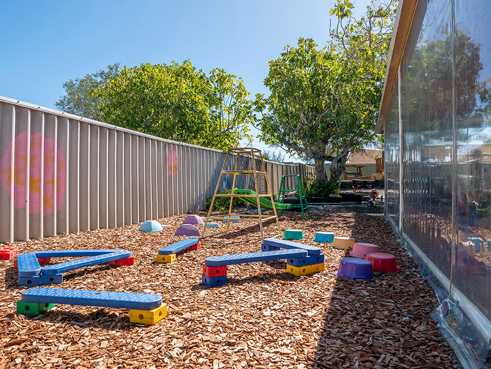 Step and balance play equipment in outdoor playground at Albany childcare centre