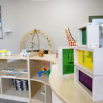 Play area with colorful storage cubbies and learning resources at Brabham childcare centre