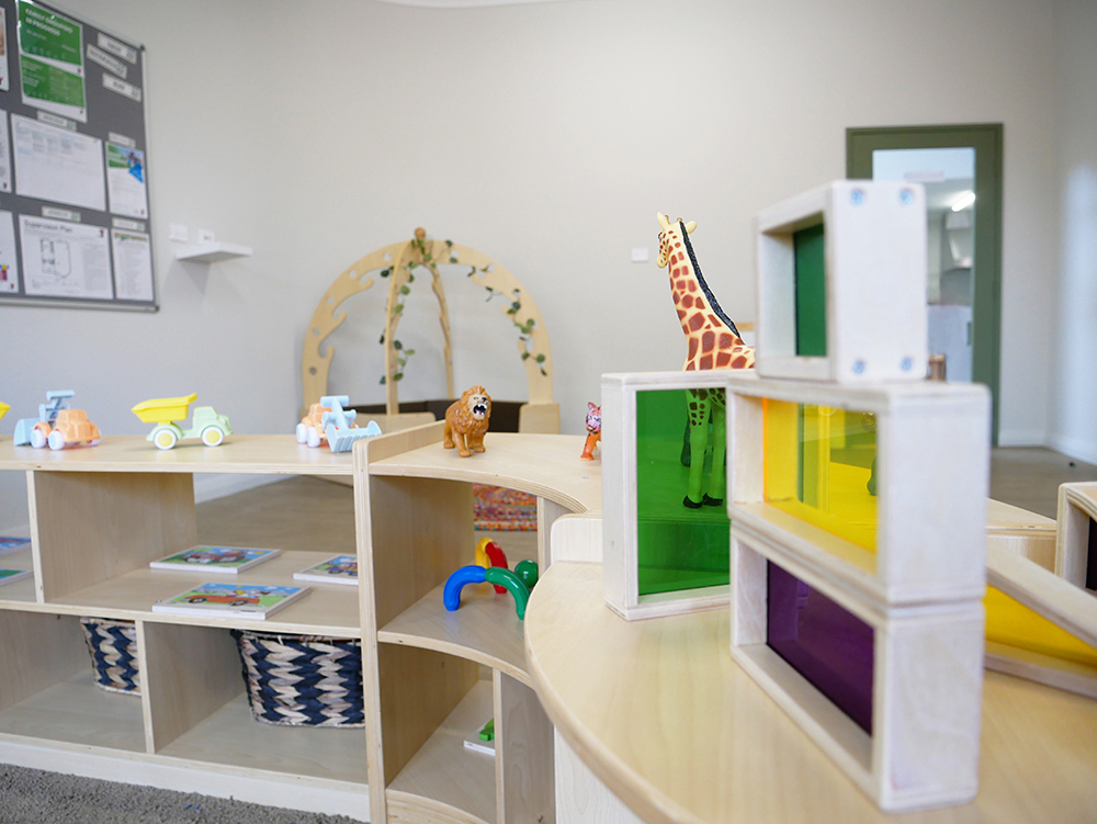Play area with colorful storage cubbies and learning resources at Brabham childcare centre