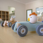 Wooden toy cars with animal figures in a bright childcare playroom at Brabham childcare centre