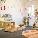 Nursery space with age-appropriate toys and children's artwork at East Cannington