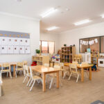 Bright learning environment with Aboriginal flag and organised activity zones at Kalgoorlie centre