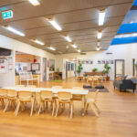 Spacious learning room with modern timber ceiling and natural furniture at Newman centre