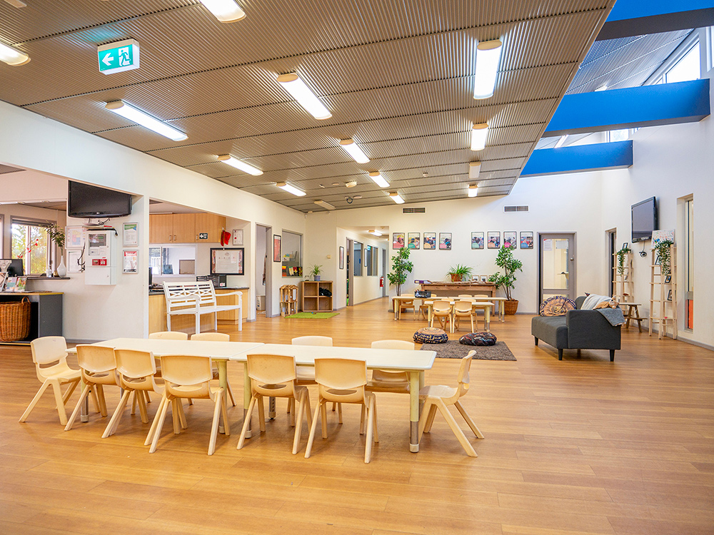 Spacious learning room with modern timber ceiling and natural furniture at Newman centre