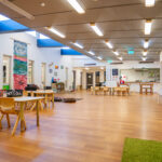 Expansive indoor space with natural light and timber features at Newman childcare centre