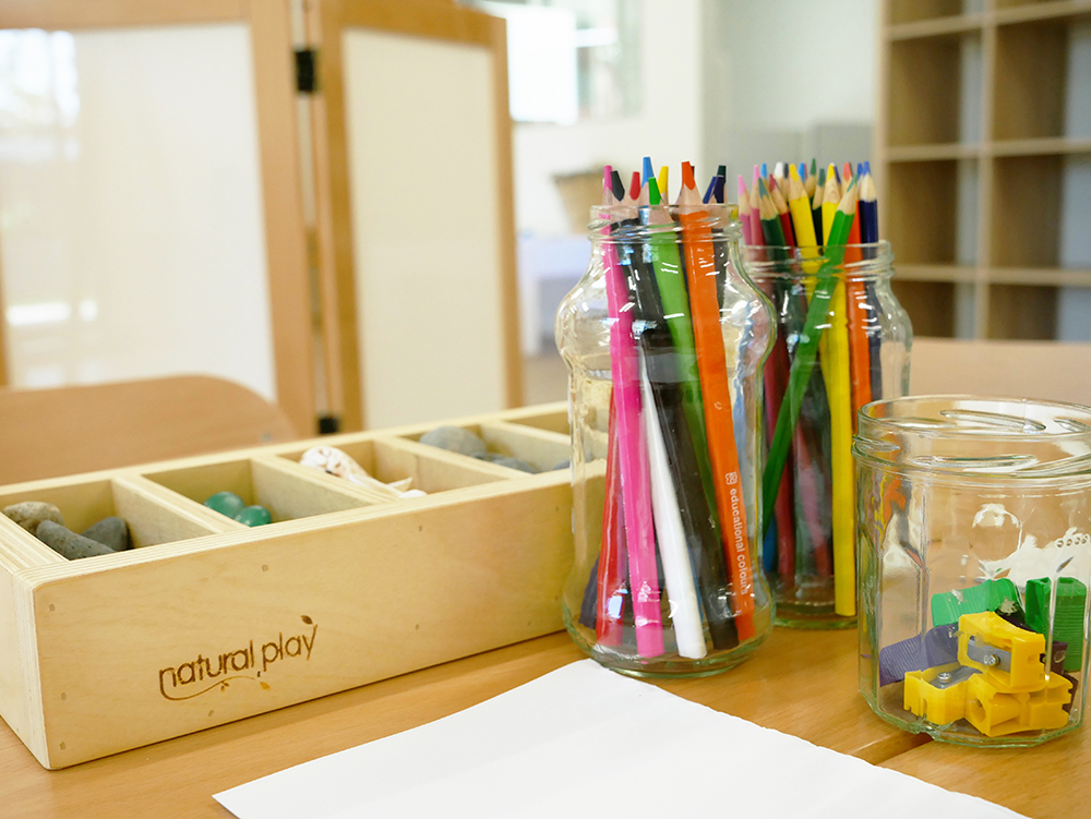 Colouring in pencils, paper and craft supplies on table at Port Hedland Early Learning Centre