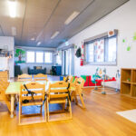 Large room with a couch, activity stations and age-appropriate toys at Port Hedland Early Learning Centre