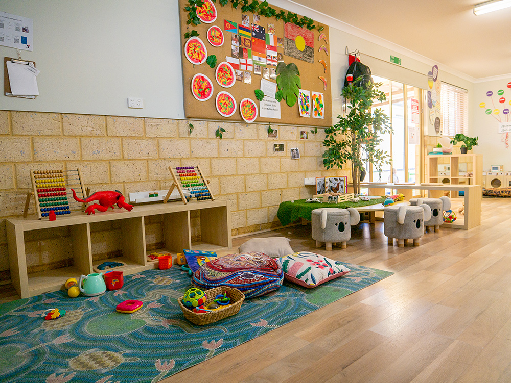 Childrens play area with toys, cushions and books at Westminster Early Learning Centre