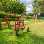 Outside play area with bikes, playground and play equipment at Yappara House Early Learning Centre