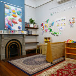 Inside play room with furniture, toys and art at Yappara House Early Learning Centre