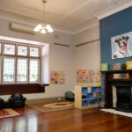 Inside chill out room with furniture and artwork at Yappara House Early Learning Centre