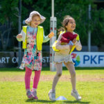 Two children laughing together during Coles Healthy Kicks sports activity at Y WA OSHC School Holiday Program