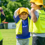 Children smiling during COles Healthy Kicks activity at Gumtrees OSHC School Holiday Program