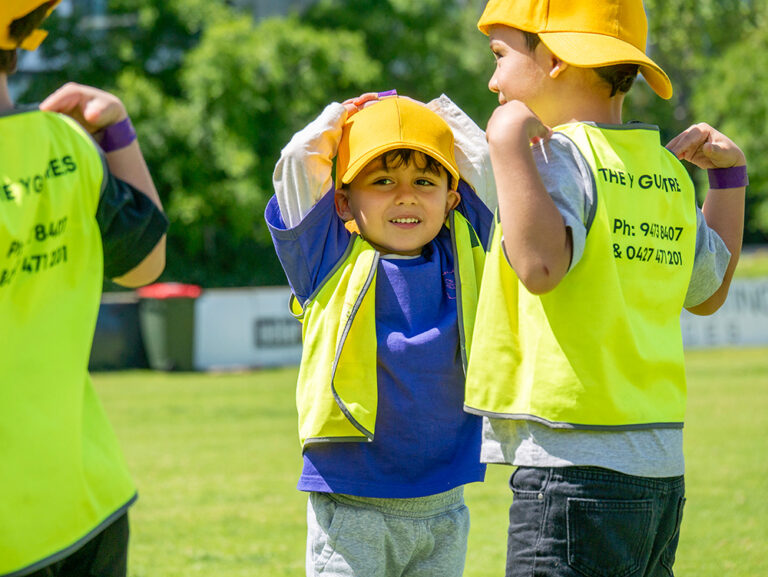 Children smiling during COles Healthy Kicks activity at Gumtrees OSHC School Holiday Program
