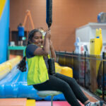 Child swinging on flying fox at Huntingdale OSHC School Holiday Program