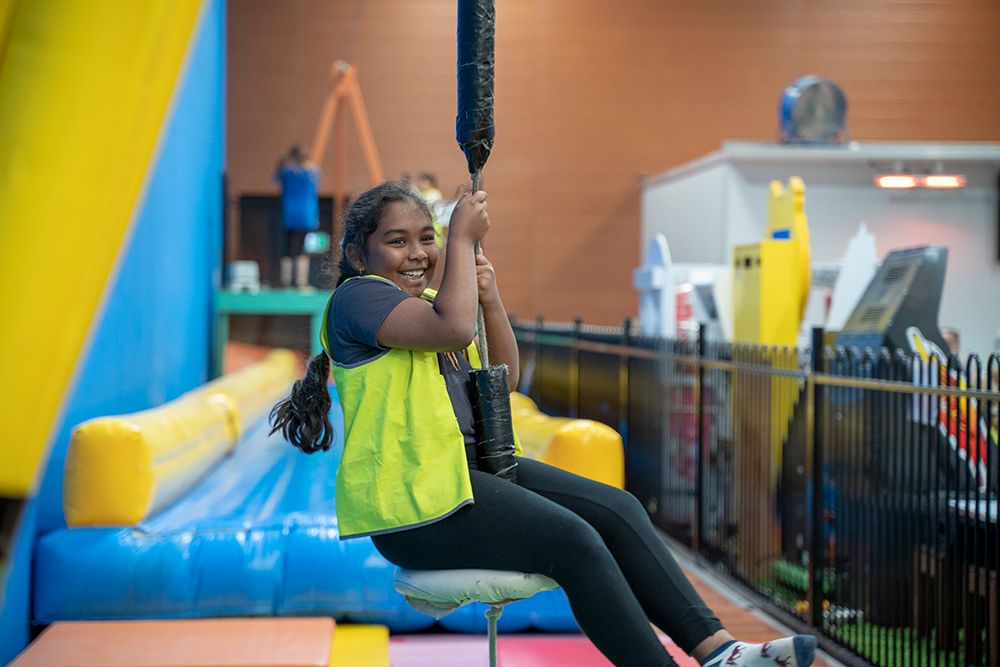 Child swinging on flying fox at Huntingdale OSHC School Holiday Program