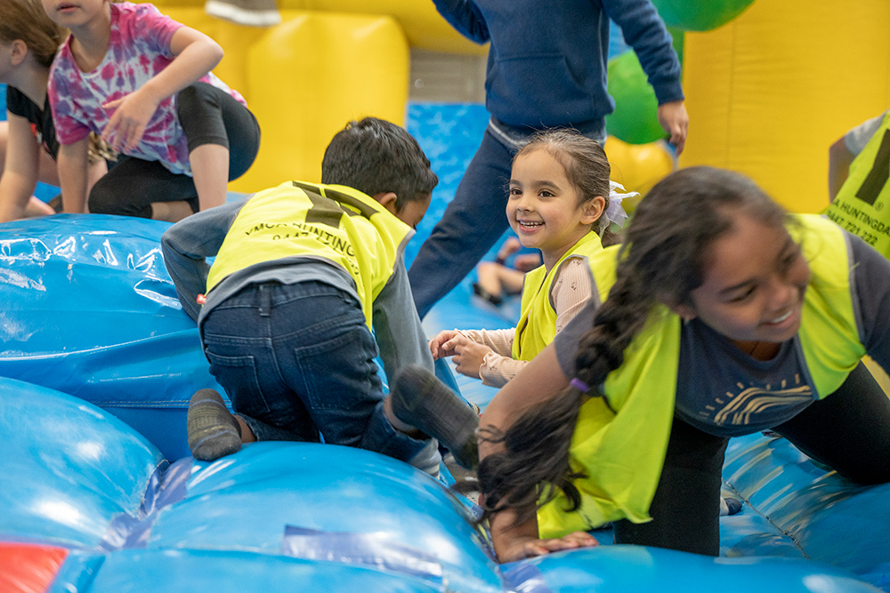 Children playing on bouncy castle at Huntingdale OSHC School Holiday Program