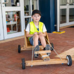 Child sitting in go-kart at Mercy OSHC School Holiday Program