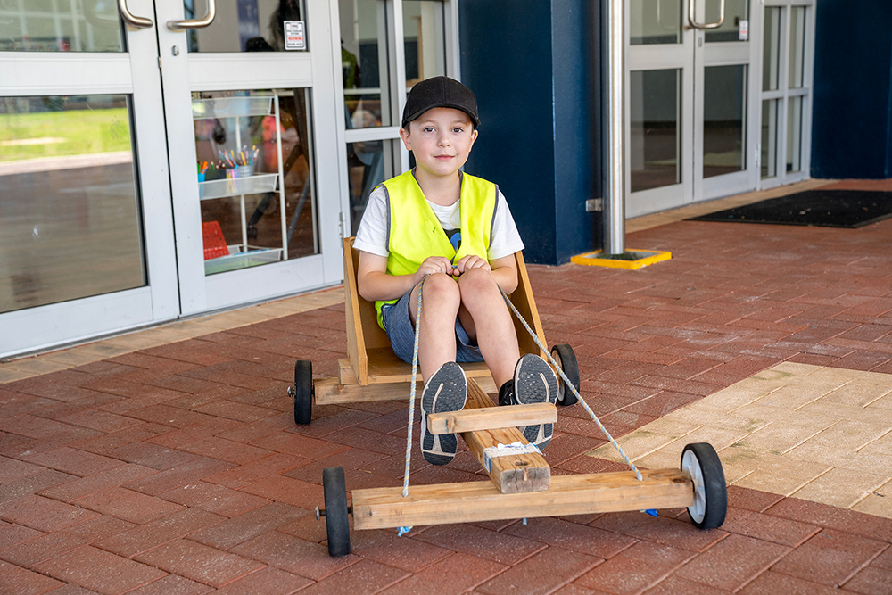 Child sitting in go-kart at Mercy OSHC School Holiday Program