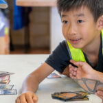 Child playing card game at Riverton OSHC School Holiday Program