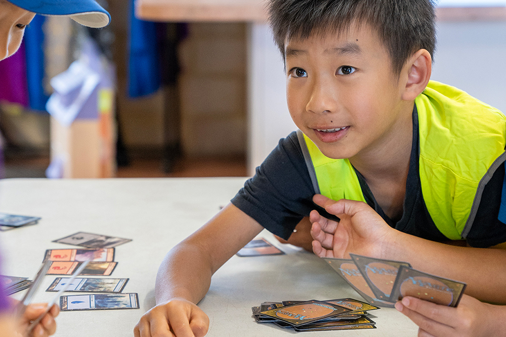 Child playing card game at Riverton OSHC School Holiday Program