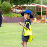Child playing on the oval at Sacred Heart OSHC School Holiday Program