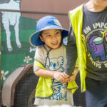 Children exploring Old Macdonald's Travelling Farm during Sacred Heart OSHC School Holiday Program