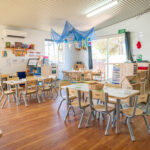 Tables and chairs in activity room at Albany childcare centre