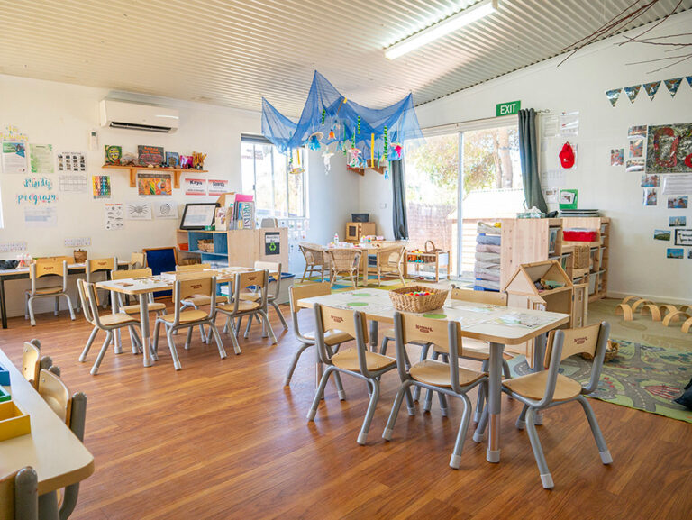 Tables and chairs in activity room at Albany childcare centre