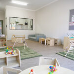 Spacious nursery room with climbing frames, storage units, and soft play areas at Brabham childcare centre