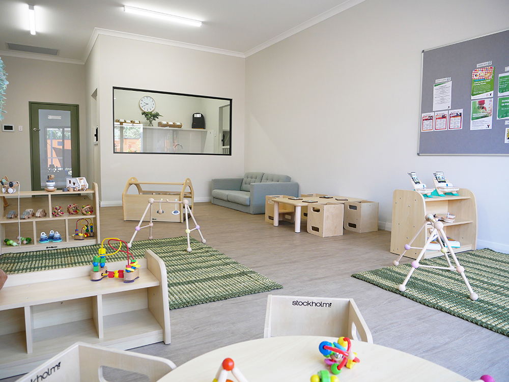 Spacious nursery room with climbing frames, storage units, and soft play areas at Brabham childcare centre