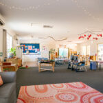 Spacious learning room with activity stations and Indigenous art rug at East Cannington childcare