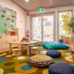 Play space with child kitchen area and nature elements at Newman childcare centre