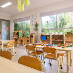 Room with tables, chairs, and other play equipment at Yappara House Early Learning Centre
