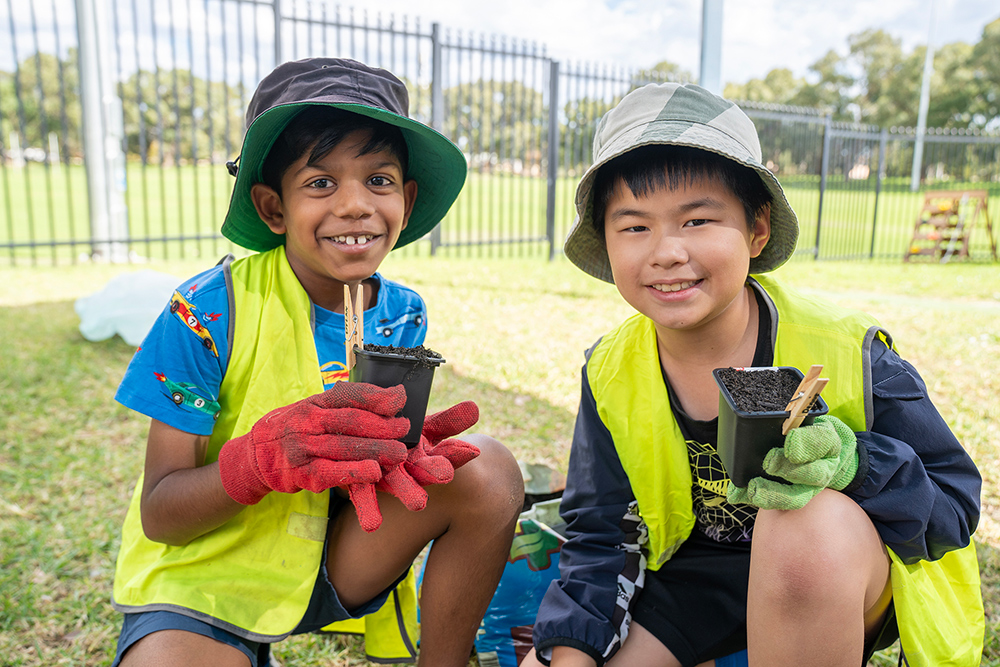 Children potting plants during an activity at Riverton OSHC School Holiday Program
