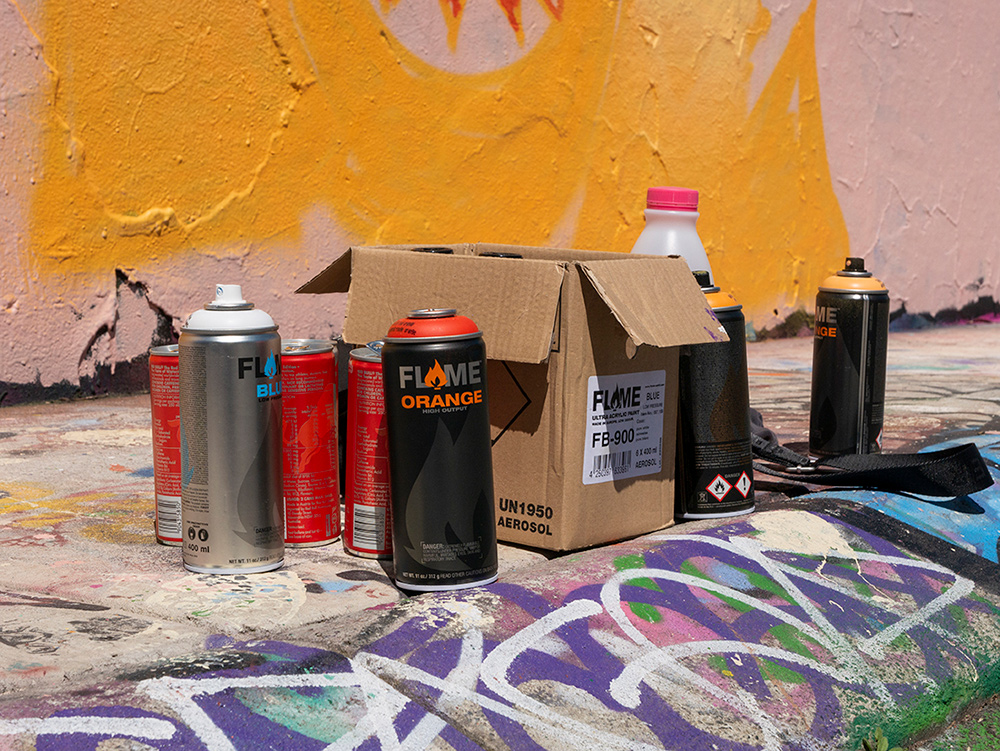 Close up of spray paint cans on side of the road