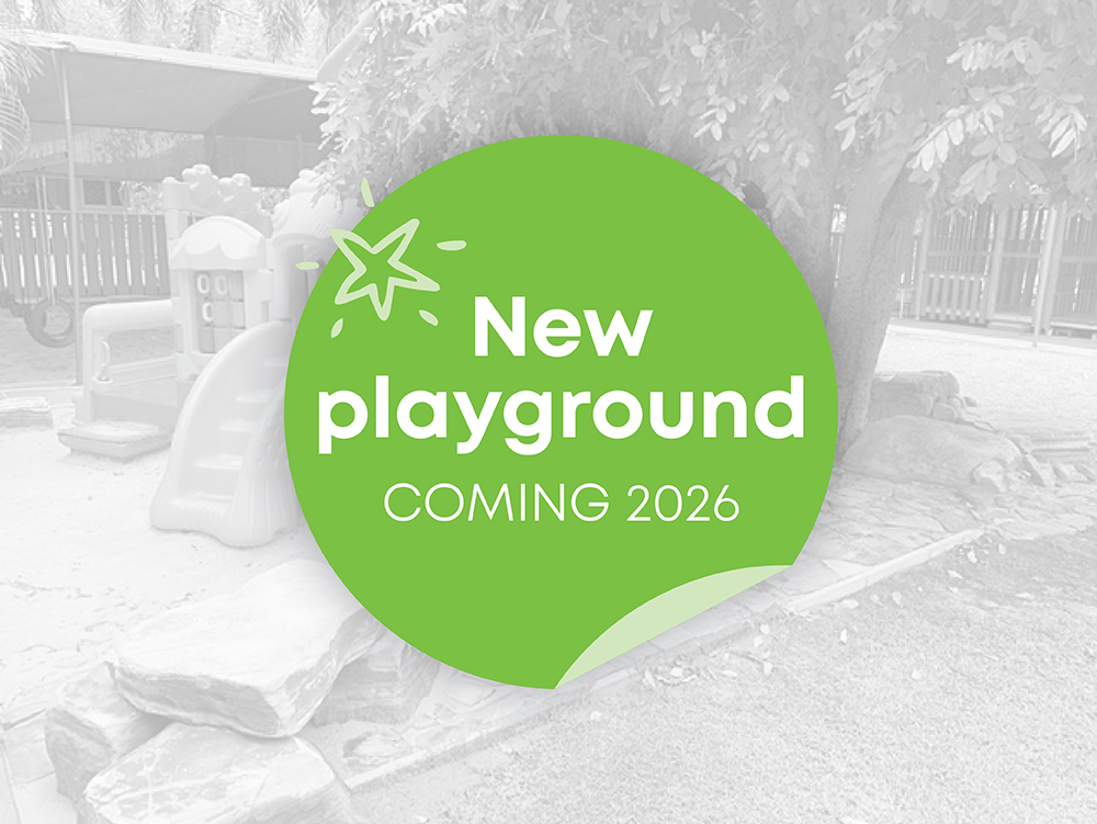 A promotional graphic announcing a new playground coming in 2026, overlaid on a greyscale photo of an existing children's play area
