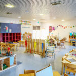 Bright playroom with colourful age appropriate furniture, toys and artwork.