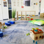 Childrens play area with carpet, pillows, blocks and books