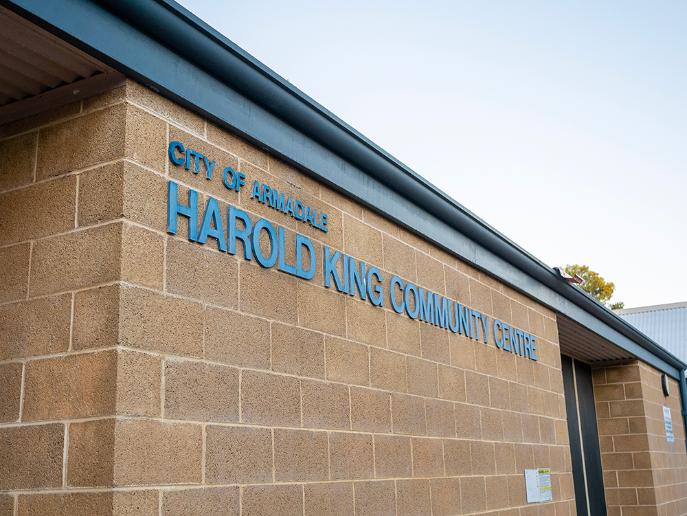 Exterior brick wall of the City of Armadale Harold King Community Centre with blue signage