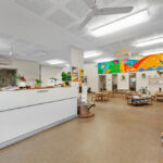 Large reception area at Tambrey Early Learning Centre with furniture and artwork on the walls