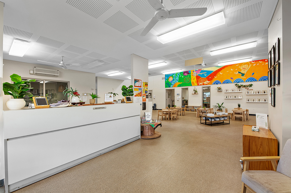 Large reception area at Tambrey Early Learning Centre with furniture and artwork on the walls