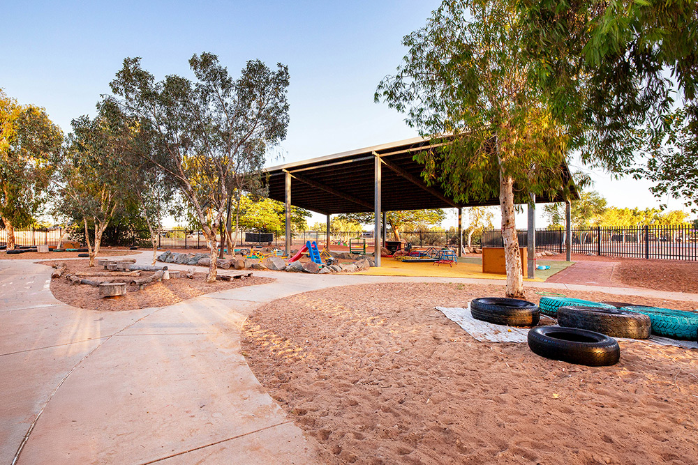 Outside play area with play equipment, slides and toys