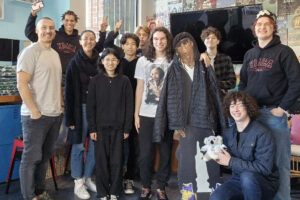 Group of young people and youth workers smiling in room at the Y HQ in Leederville