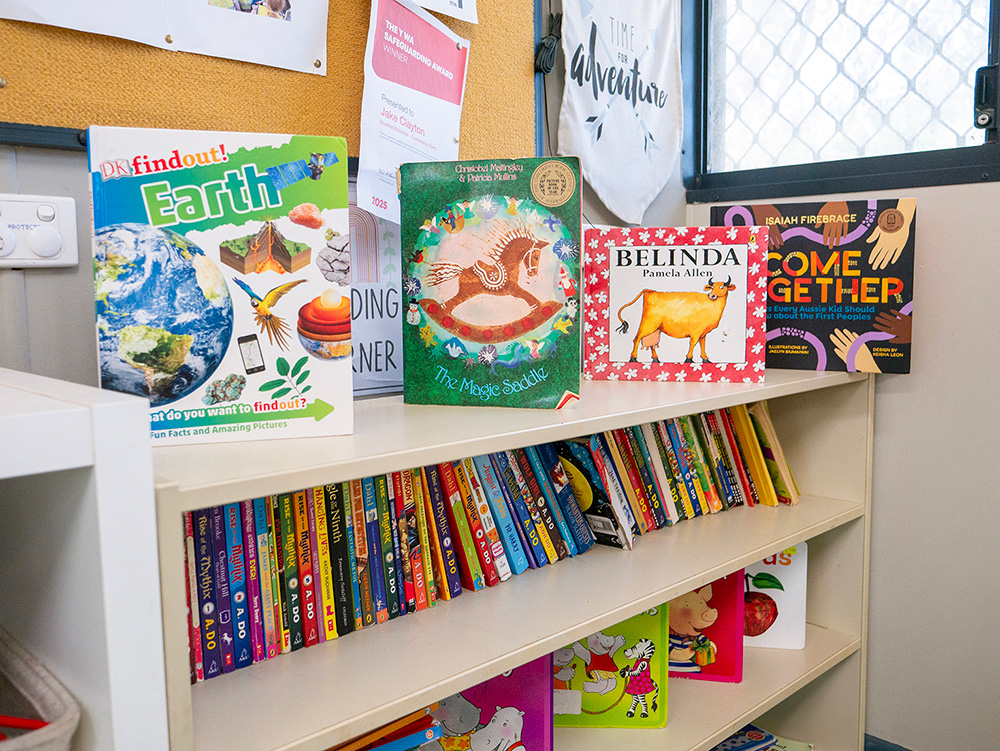 Children's bookshelf with diverse reading materials including Indigenous and multicultural titles