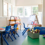 Bright OSHC art room with child-sized tables, easels, art supplies and natural window light