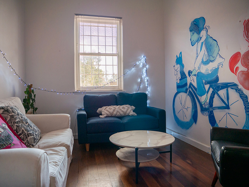 Private room with multiple couches and table inside the Y HQ in Leederville