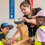 Children and educator collaborating on a go-kart project during Mercy OSHC School Holiday Program