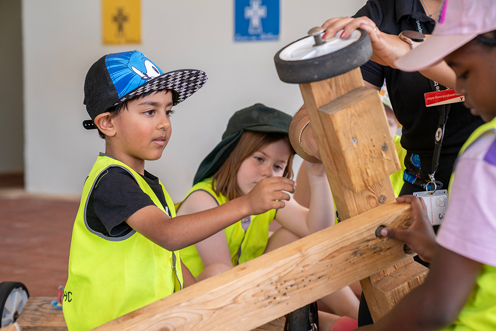 Children collaborating on a go-kart project during Mercy OSHC School Holiday Program