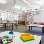 Bright OSHC classroom with Lego building activities, multicultural displays and whiteboards